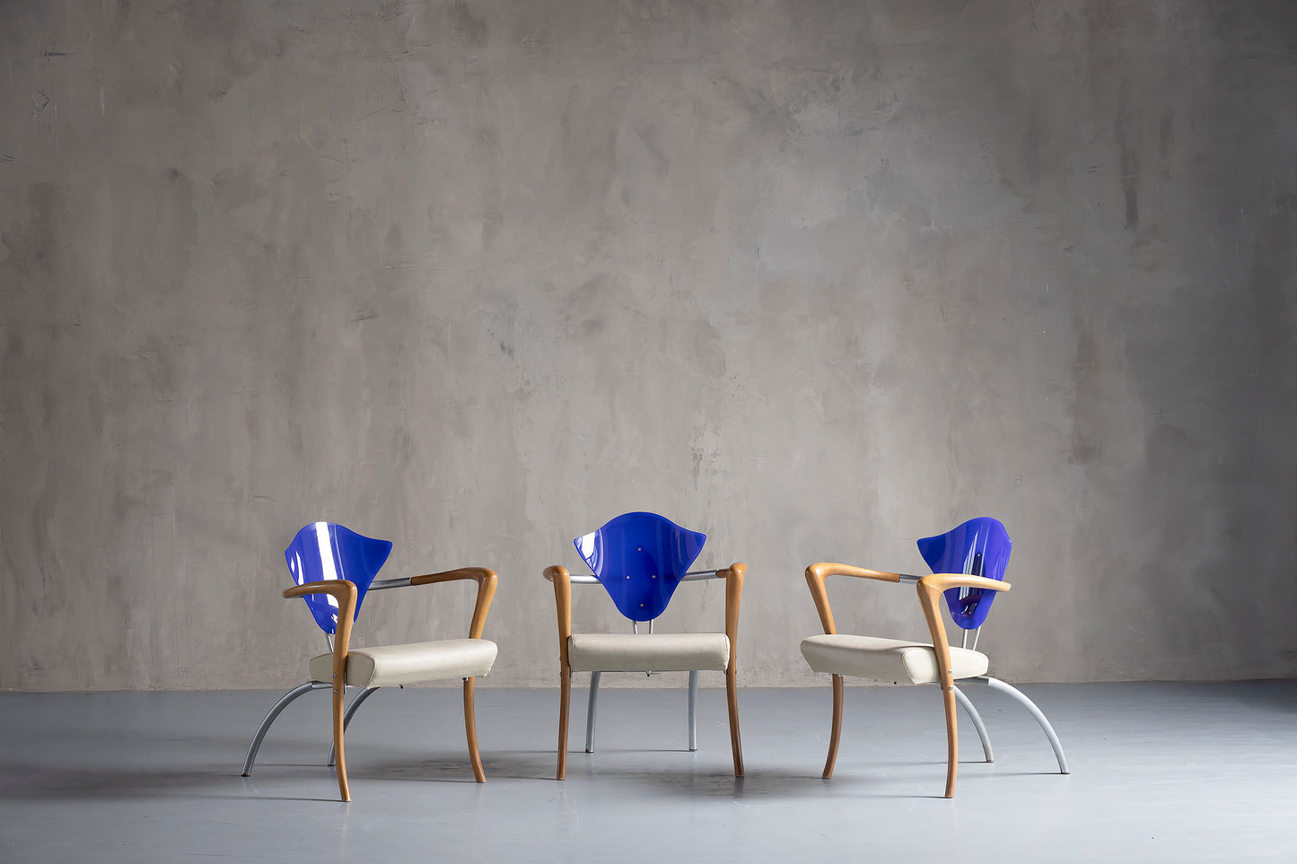 three beautiful blue chairs with wood accents