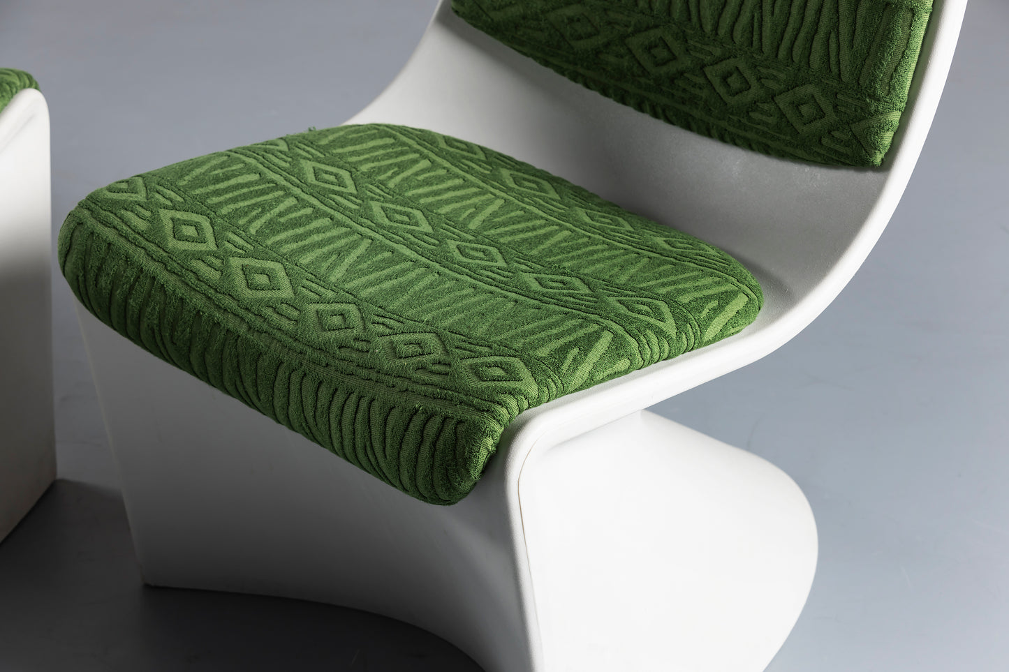 close up of white and green space design chair