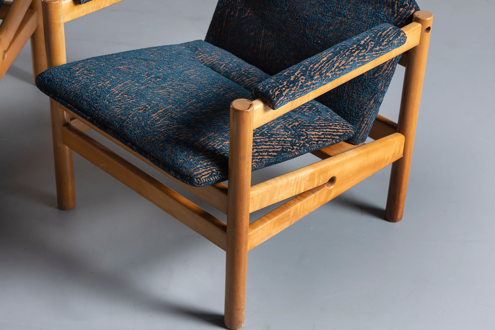 blue chair with wood legs, upclose