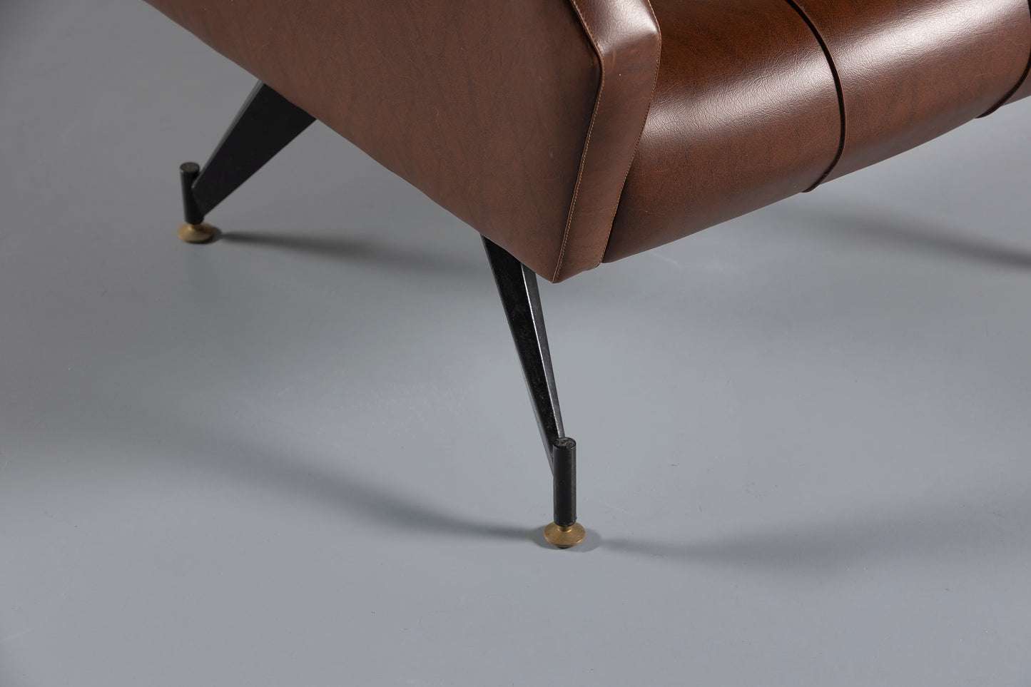 Legs of a Brown leather armchair