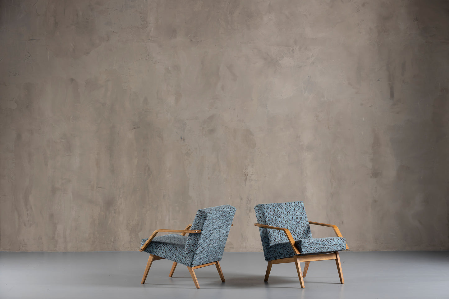 two grey chairs in a room