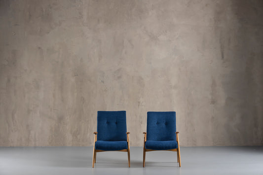 Two blue chairs in an empty room