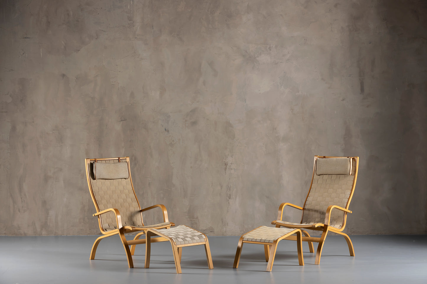 Two wood armchairs with footrests