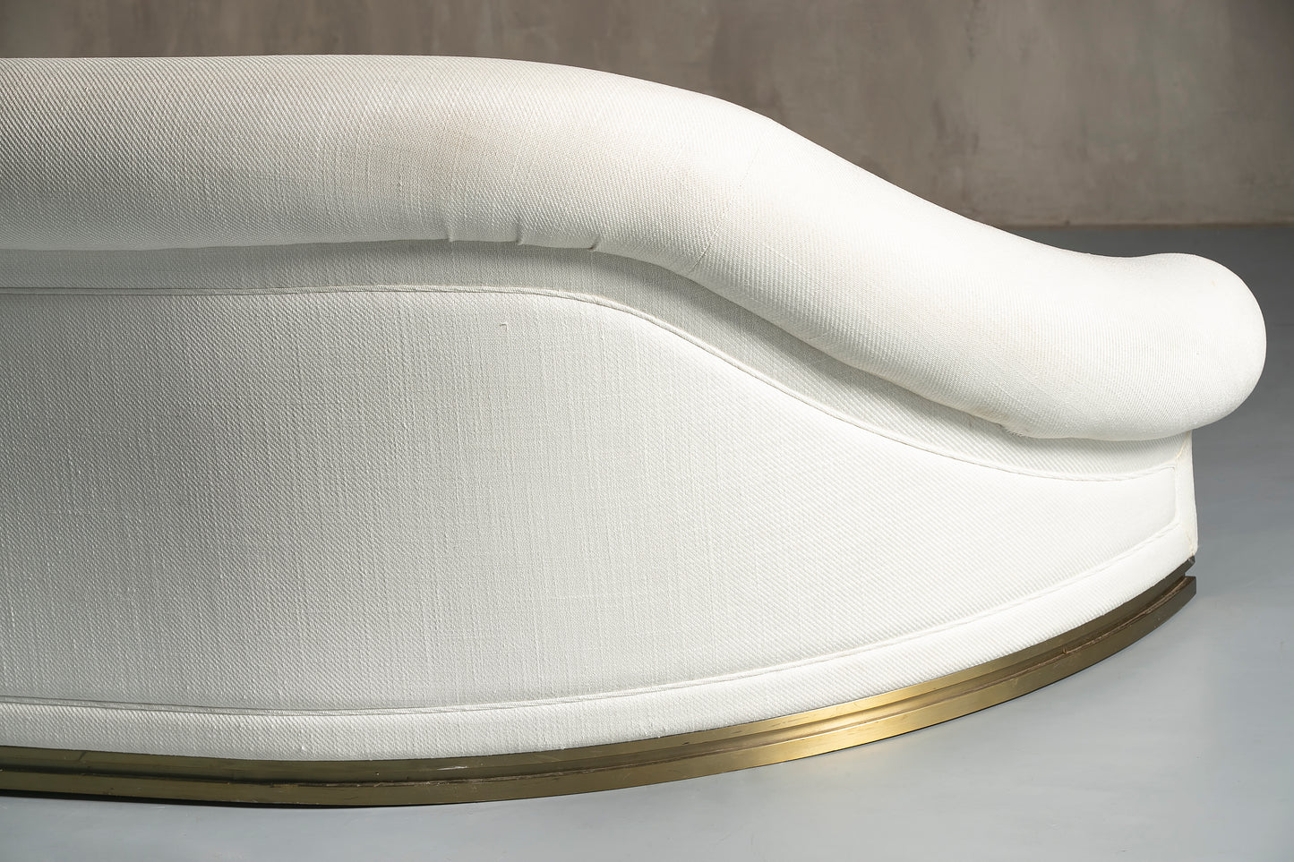 The back of a white and gold sofa