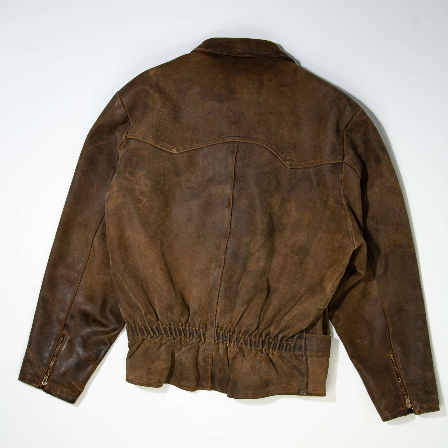 backside of a brown woman’s bike leather jacket
