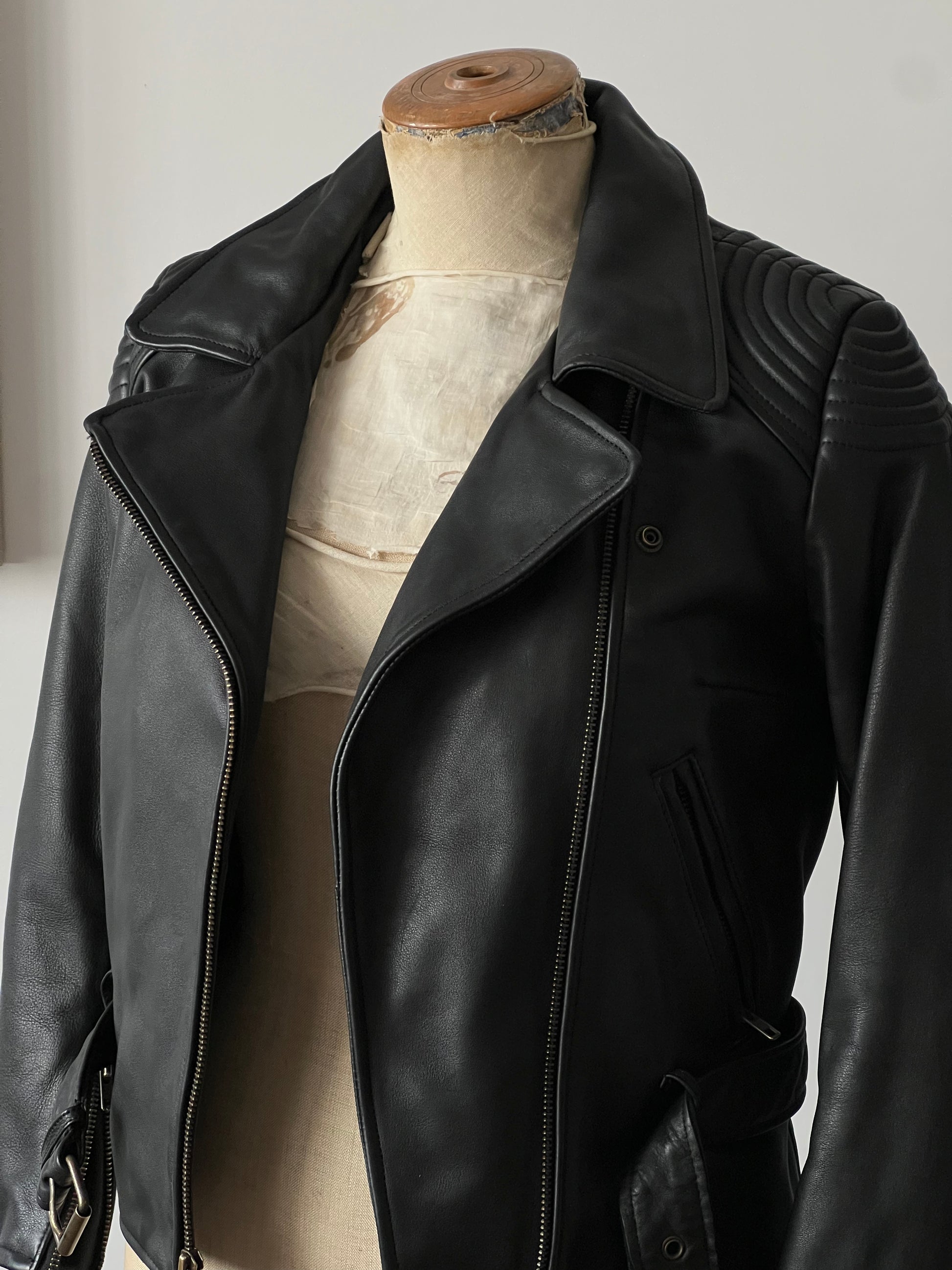 black woman’s leather jacket, mannequin