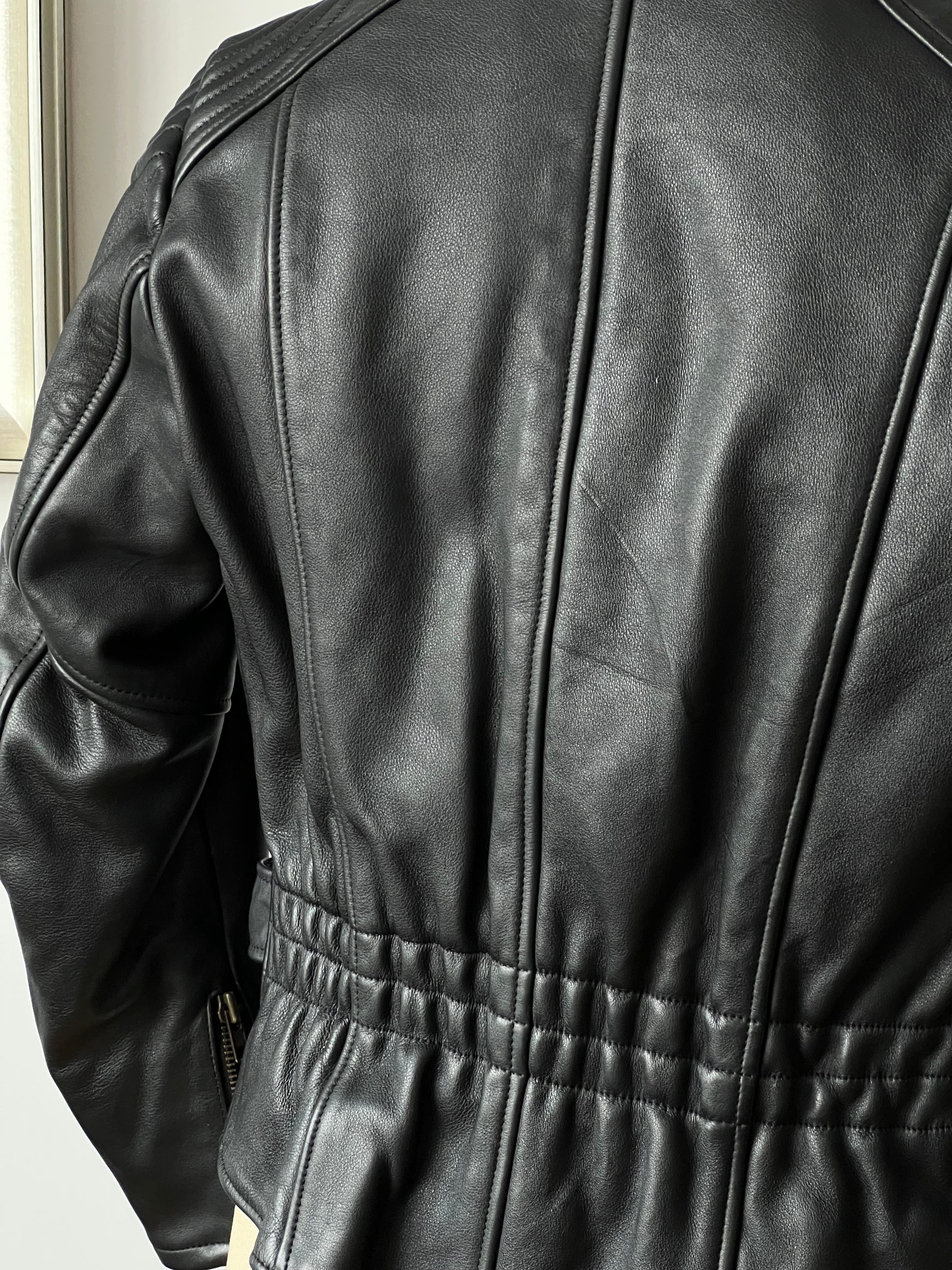 black woman’s leather jacket back