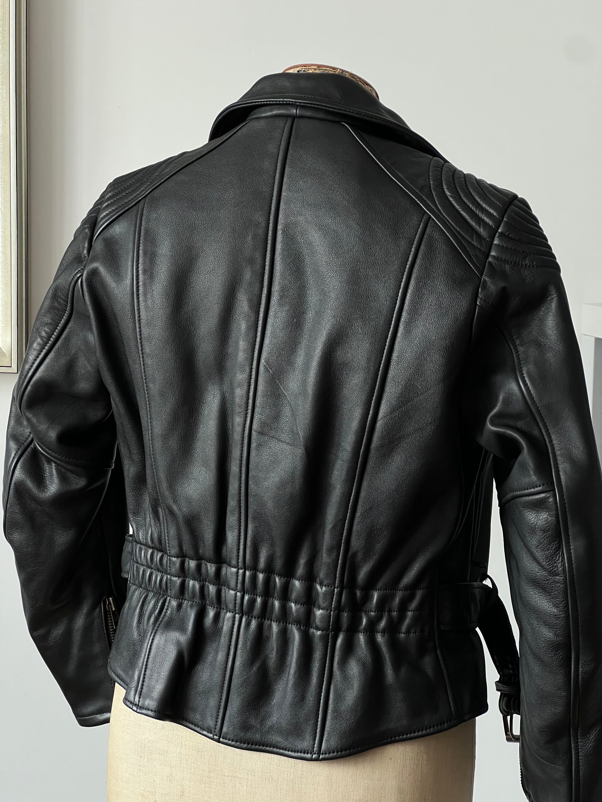 black woman’s leather jacket back on a mannequin