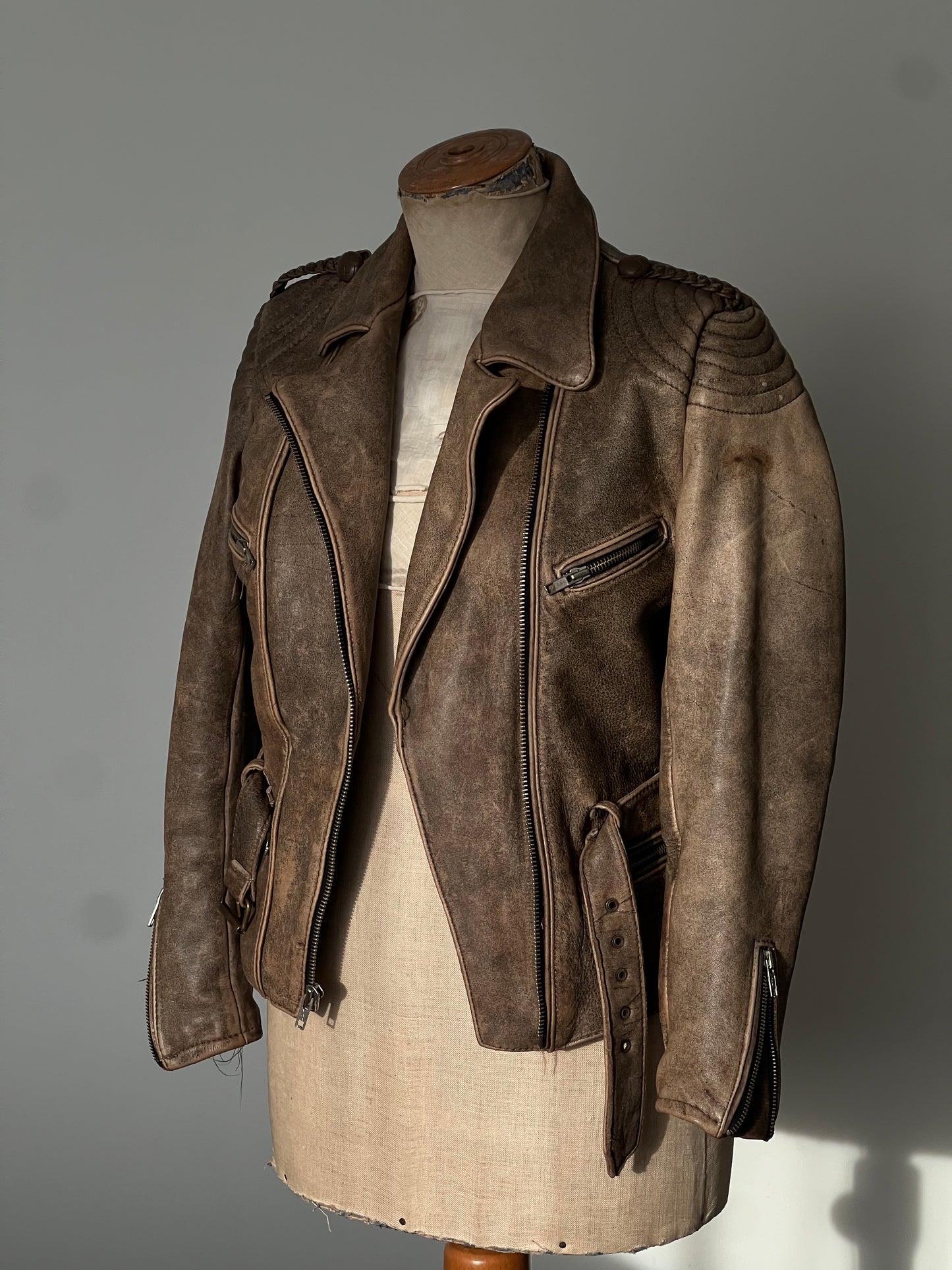 brown woman’s leather jacket on a mannequin