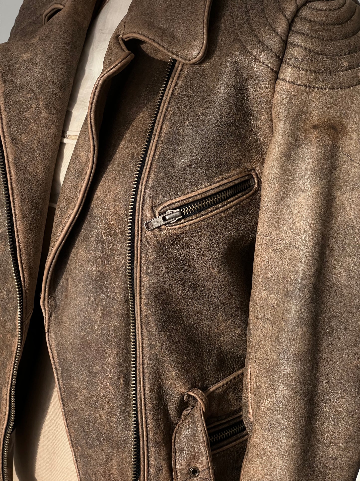 brown woman’s leather jacket pocket