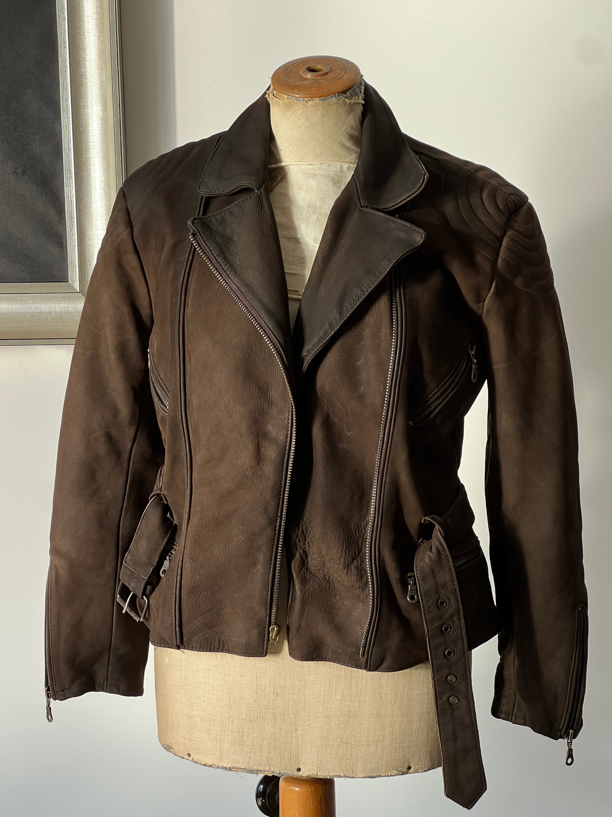 brown suede leather women’s jacket on a mannequin