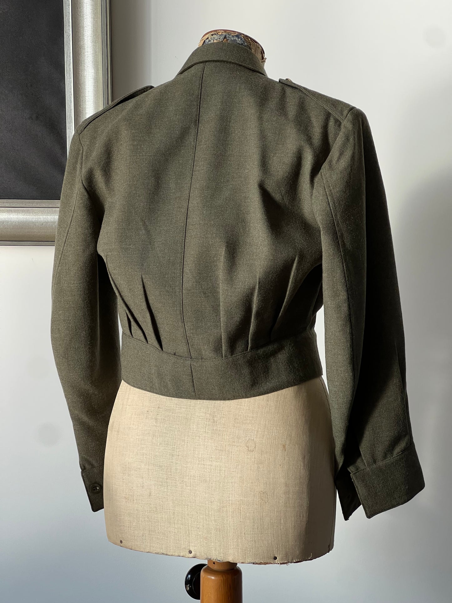 The back of army women’s jacket on a mannequin