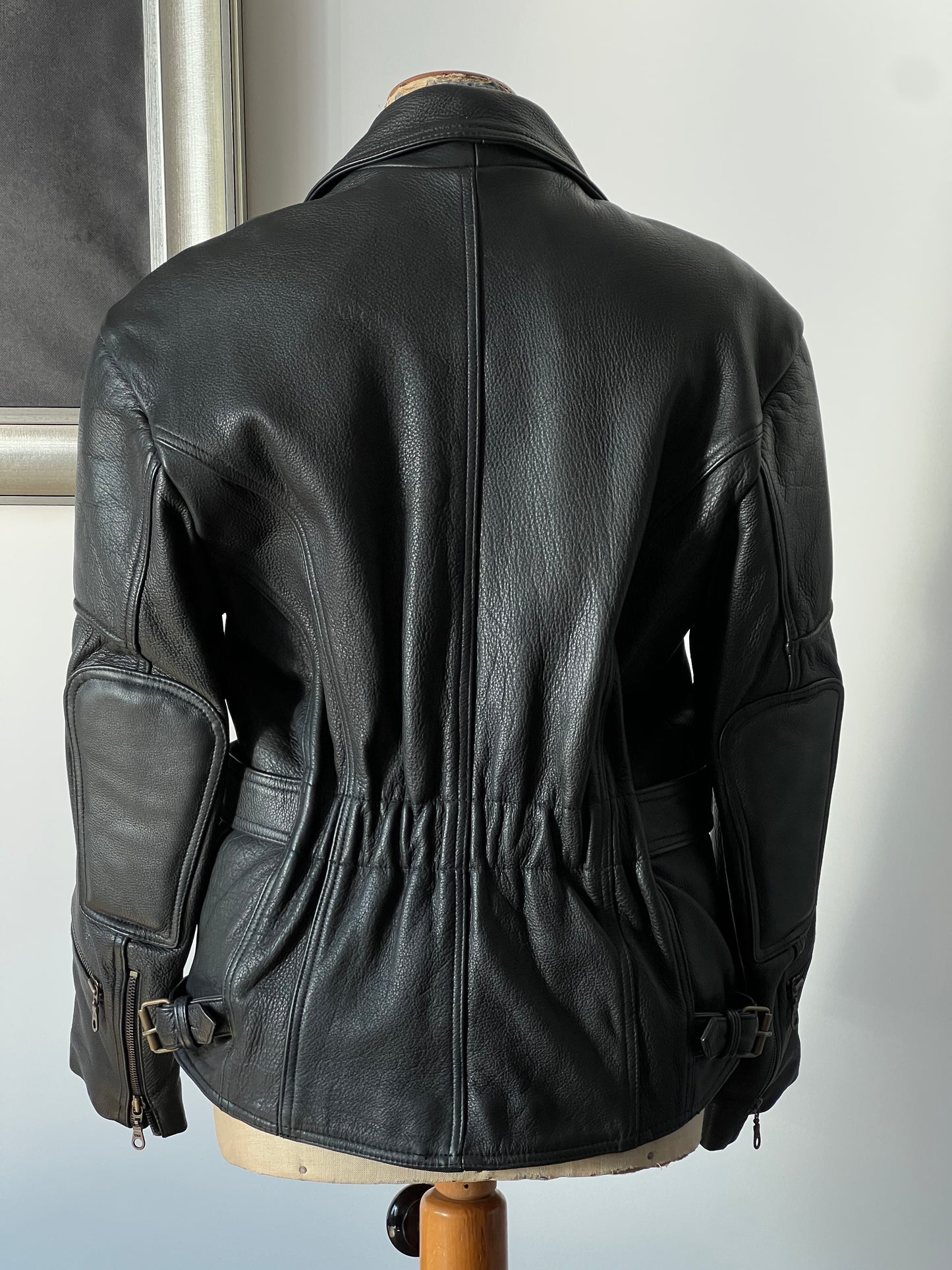 black woman’s leather jacket back