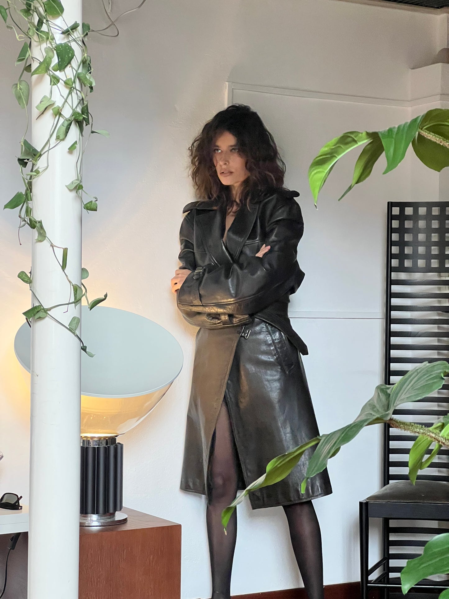 woman wearing black leather trench coat in a room