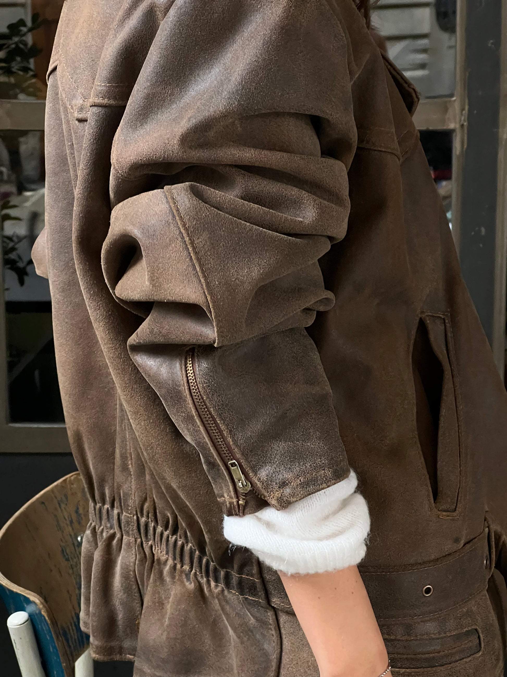 woman wearing a brown woman’s bike leather jacket sleeve