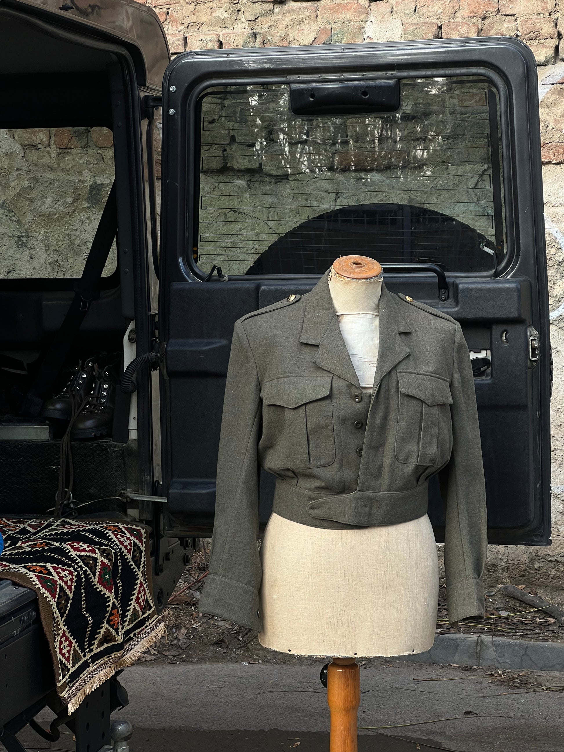 Army women’s jacket beside an army truck