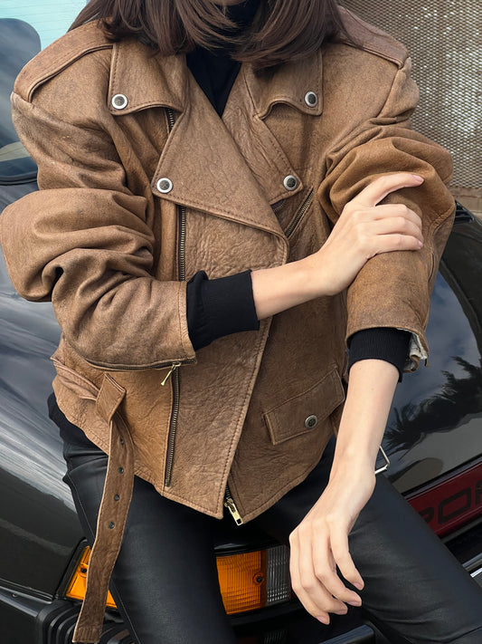 woman wearing a brown women’s biker leather jacket sleeve